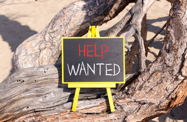 Wall Mural - Help wanted and support symbol. Concept words Help wanted on beautiful black yellow blackboard. Beautiful tree background. Business, support, help wanted concept. Copy space.