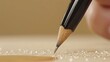   A tight shot of someone writing on paper, studded with water droplets, and a nearby pencil in the foreground