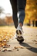 © Stavros - Jogging workout in autumn forest. Vertical photo of a female legs close-up. Woman during jogging workout in an autumn city park. Keeping fit in any age.