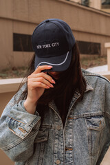 Wall Mural - Street style cloth, woman wearing vintage denim jacket and blue cap with text New York