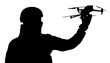 Silhouette of a soldier launching a drone. Military aerial reconnaissance. The use of drones in military operations. War. A man holding a drone in his hand.