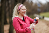 Fototapeta Miasto - Woman Holding Water Bottle After Training Outdoor