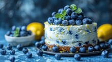   A Tight Shot Of A Cake On A Dish, Adorned With Blueberries And Slices Of Lemon Beside It