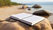 Blank book model placed on rocks in the sand, notebook mockup, mockup on nature background 