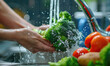 Woman washing vegetables with a vigorous splash of water