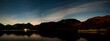 A panoramic view of the night sky over Aira Force Steamer pier on Ullswater on a winters night.