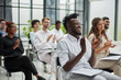© Katsiaryna - Group of business people applauding speaker after presentation