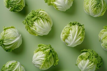 Fresh cabbage heads on a vibrant green background. Perfect for food and agriculture concepts
