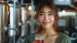 A woman smiles while holding a glass of beer at a bar event at the bay breeze