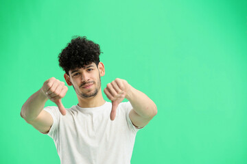 Wall Mural - A man, on a green background, in close-up, shows his finger down