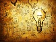 © alphaspirit - Illuminated lightbulb on a backdrop of hand-drawn business and strategy sketches