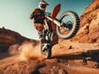 A man on a dirt bike is doing a wheelie on a rocky hill. Concept of excitement and adrenaline as the man skillfully maneuvers the motorcycle