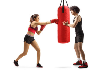 Wall Mural - Female practicing box and man holding a punching bag