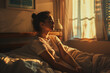 © Lucas Comba - Upon waking, a woman reclined on the bed, feeling the gentle touch of the morning sun