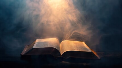 Open bible on a dark background with rays of light and smoke