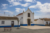 Fototapeta Uliczki - City of Porto Covo  with traditional Alentejo houses painted white with blue strip and red windows. Streets of the picturesque village of Porto Covo, located in the vicentine coast, Portugal.