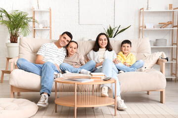 Canvas Print - Happy family watching TV on sofa at home