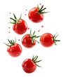 Falling fresh organic tomatoes over isolated transparent background