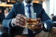 © Nia™ - businessmen holding a glass of whiskey - generative ai