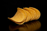 Fototapeta  - Close-up with a few (a bunch) of potato chips on a black background