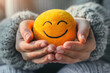 Closeup view of a Woman hand holding a very detailed happy smile 3D sphere emoji, mental health concept, positive thinking, support and evaluation
