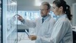 © BrightWhite - Engaging intellectual discussion between two scientists analyzing data on a digital screen, dressed in lab coats, embodying teamwork in technology.