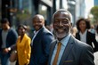 © Iigo - Portrait of a senior African businessman with his team in the background