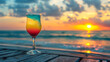 Rainbow cocktail on beach with beautiful sky and sunset