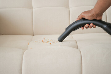 Wall Mural -  Cleaning Sofa with Vacuum Cleaner in living room