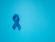 Blue ribbon on a blue background. Awareness of prostate cancer in men's health.