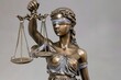 In-depth of the bronze figure of the goddess of justice bearing a blindfold and holding a sword and the scales of justice over a pale setting and space, Generative AI.