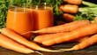 Carrot Juice a lot of vitamin A. Protects Eye. High Source of Antioxidants Especially Beta Carotene. Decreases Risk for Heart Disease. Helps Protect Against Cancer. Raw carrots and juice in a glass.