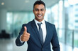 © Niks Ads - Young indian businessman showing thumps up