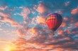 Balloons floating above the colorful sunrise sky