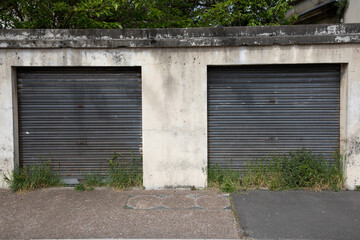 Wall Mural - Old weathered two double rusty steel door closed metal building facade car garage