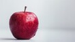 A red apple set against a white backdrop