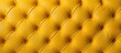 Closeup of a luxurious yellow tufted leather couch