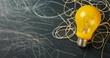 Bright Ideas Concept: Yellow Light Bulb with Sketches on Chalkboard