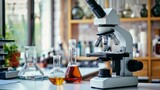 Fototapeta Sport - Scientific Exploration: Microscope and Lab Glassware in Research Laboratory Setting