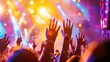 Many people in the public raising their hands at a concert or party. Concept of party and people having a good time.