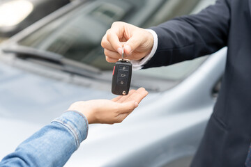 lease, rental car, sell, buy. Dealership manager send car keys to the new owner.  Sales, loan credit financial, rent vehicle, insurance,  renting, Seller, dealer, installment, car care business