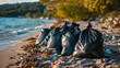 peel of disposition black garbage bags on the beach, ecological concept