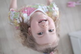 Fototapeta  - little girl looks up