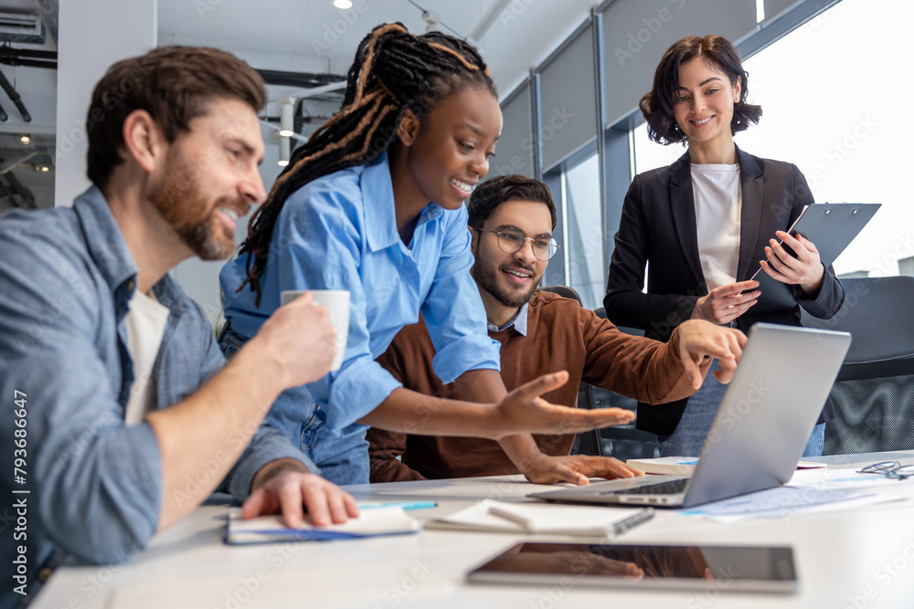 Group of diverse businesspeople using laptop while working together ...