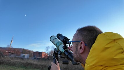 Wall Mural - amateur astronomer looking at the evening skies, observing planets, stars, moon and other celestial 
