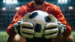 © Ruslan - The goalkeeper of a football team holds a soccer ball in his hands