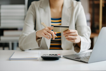 Businesswoman hand using smart phone, tablet payments and holding credit card online shopping, omni channel, digital tablet docking keyboard computer