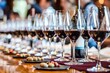 A sophisticated wine tasting setup displaying multiple glasses of red wine, completed with light snacks on a beautifully arranged table. Ideal for conveying luxury and class.