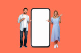 Fototapeta  - Man and woman presenting a large smartphone
