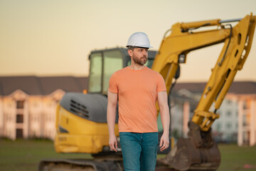 Wall Mural - Builder man at building site. Construction manager in helmet. Male construction engineer. Architect at a construction site. Handyman builder in hardhat. Building concept. Builder foreman.